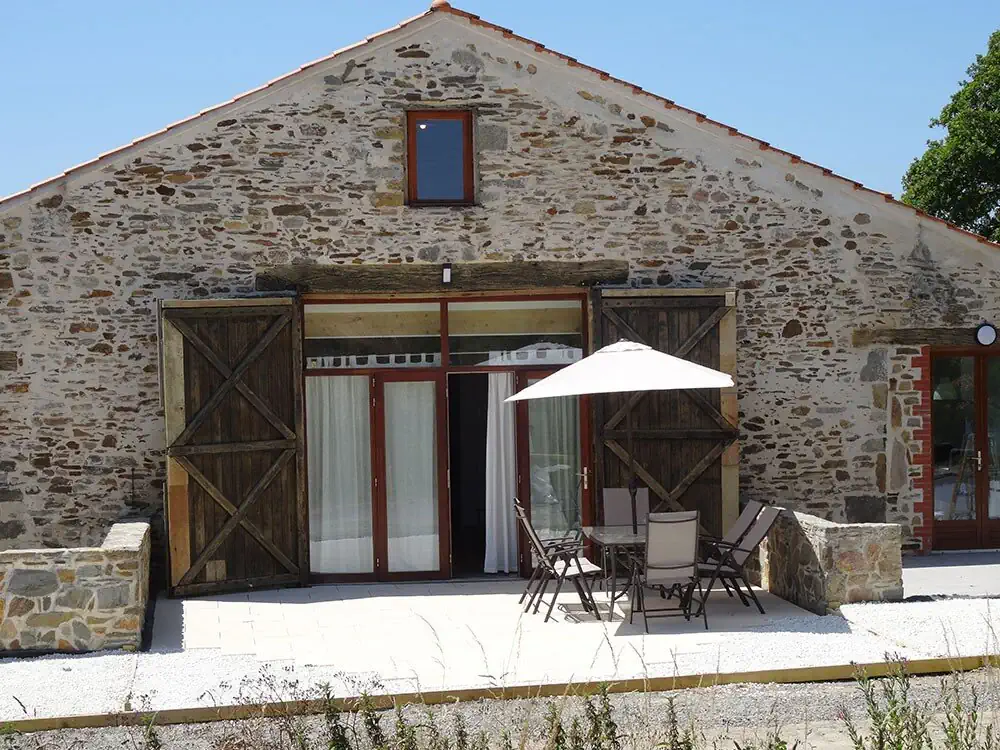 Exterior view of La Lumière Est, a spacious holiday gîte at Le Village du Bois set in the Vendée countryside