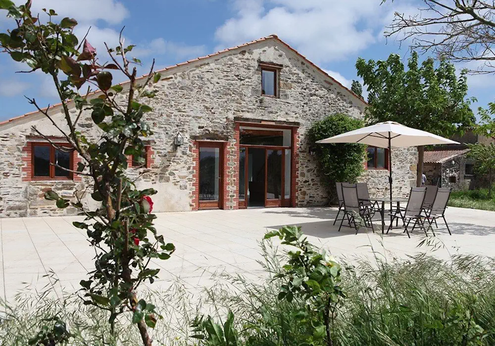 Patio of La Salle des Fêtes, an outdoor space with seating and natural light, ideal for events and gatherings